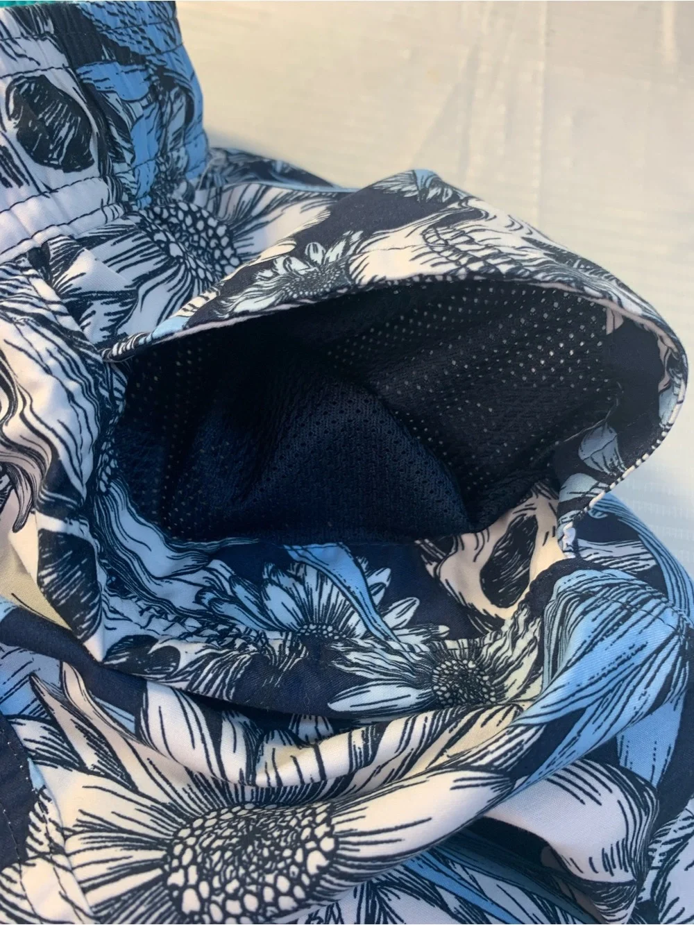 No Boundaries swim trunks feature a distinctive skull and floral pattern. SZ L